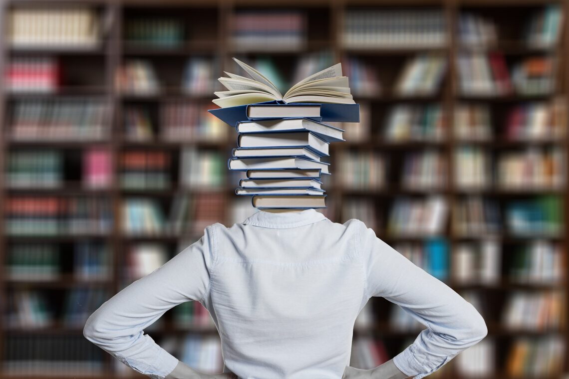 Stack of books where a persons head should be